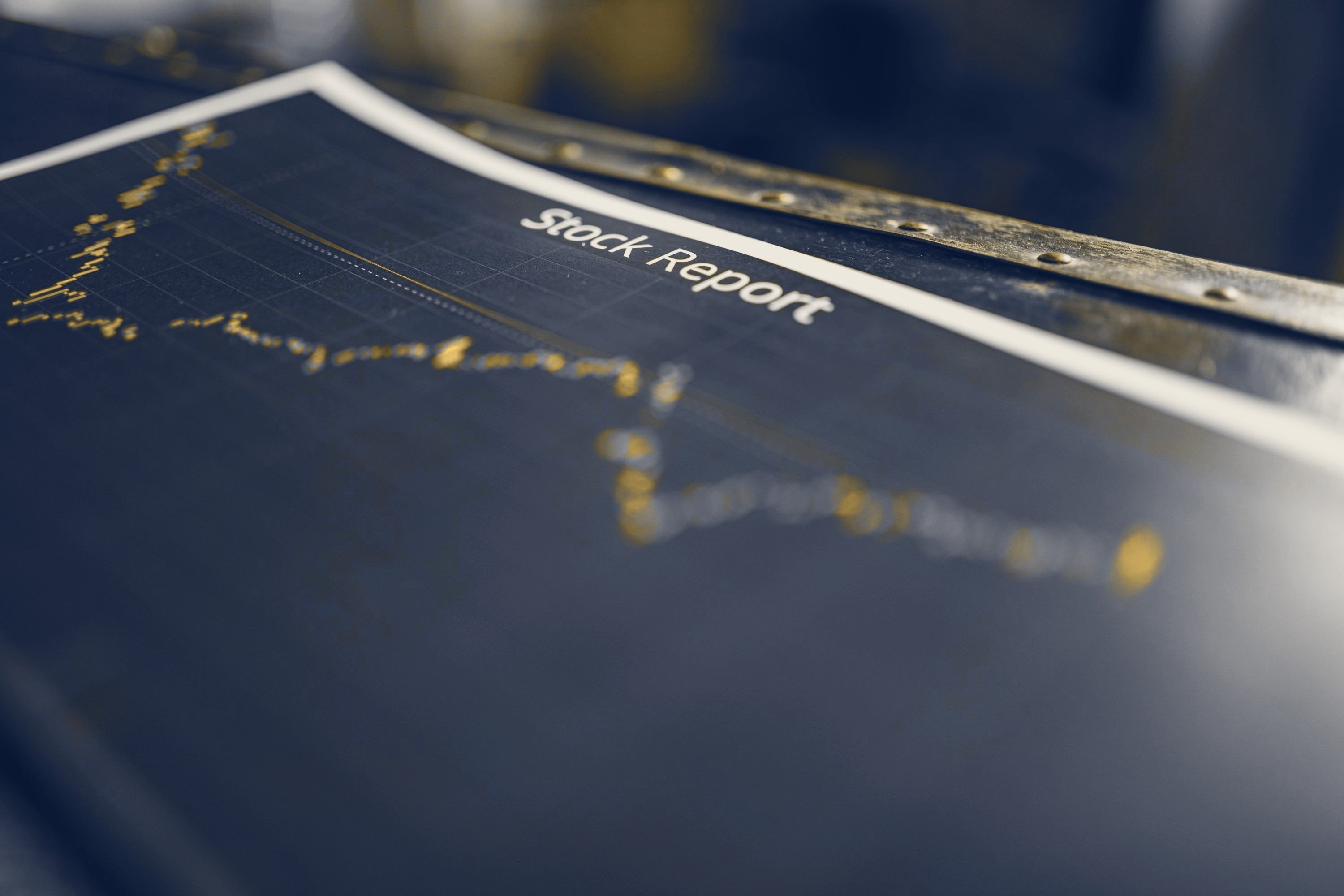 A printed stock report lying on an old desk, the chart out of focus.